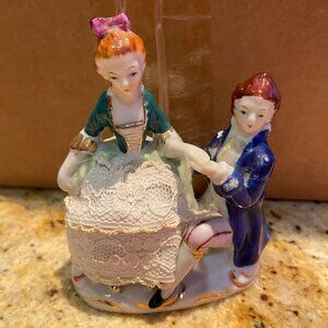 Antique colonial man and women porcelain figurines